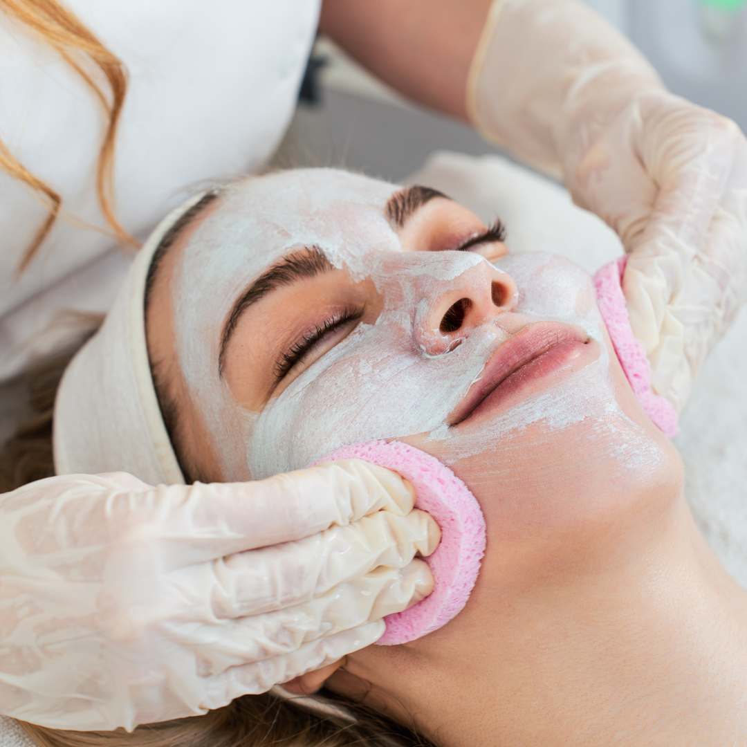 Person receiving a facial treatment with gloves on hands